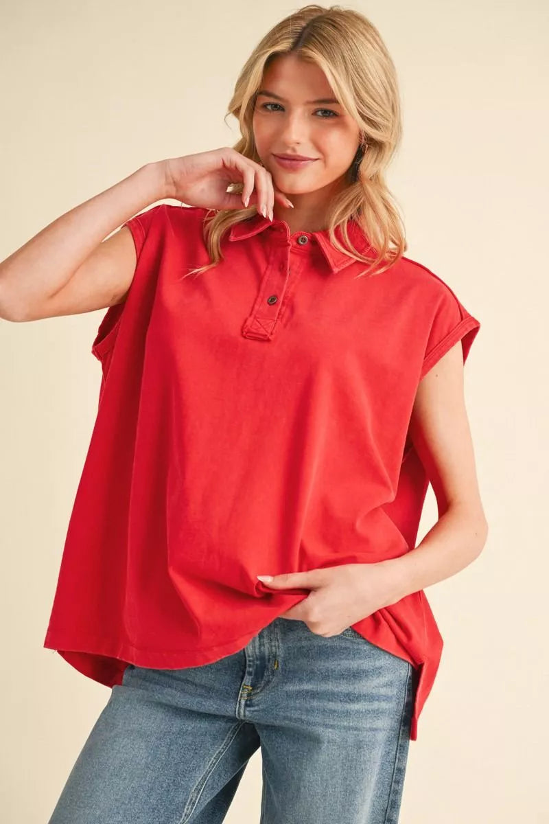 Washed cotton boxy top with collared neck featuring buttoned closure, and sleeveless.