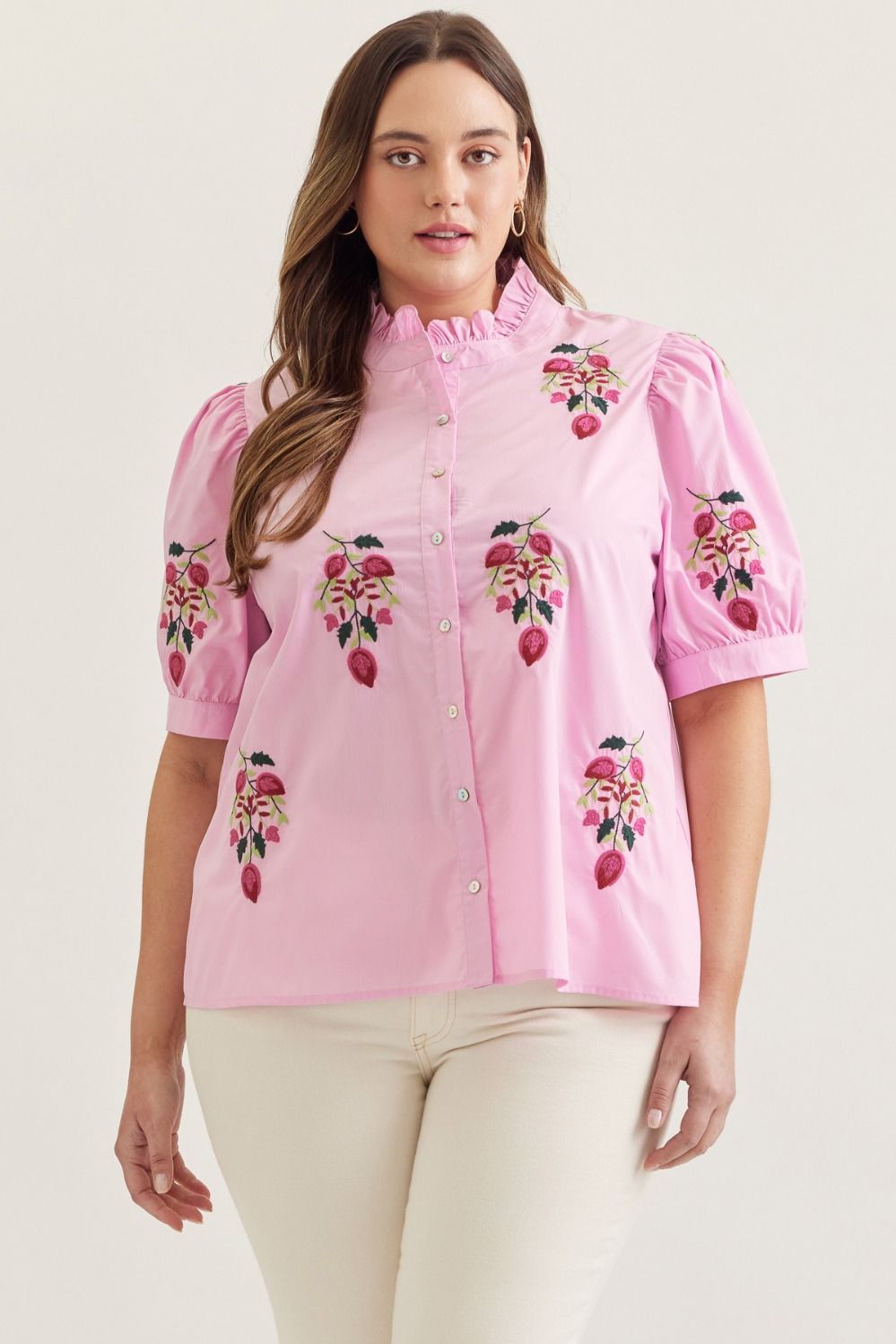 Pink solid short puff sleeve top featuring embroidered floral motif