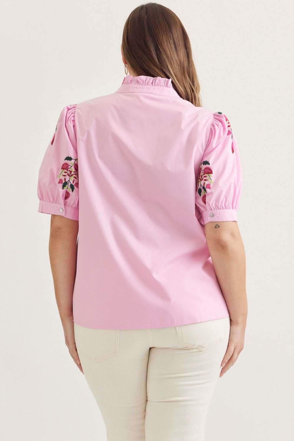 Pink solid short puff sleeve top featuring embroidered floral motif
